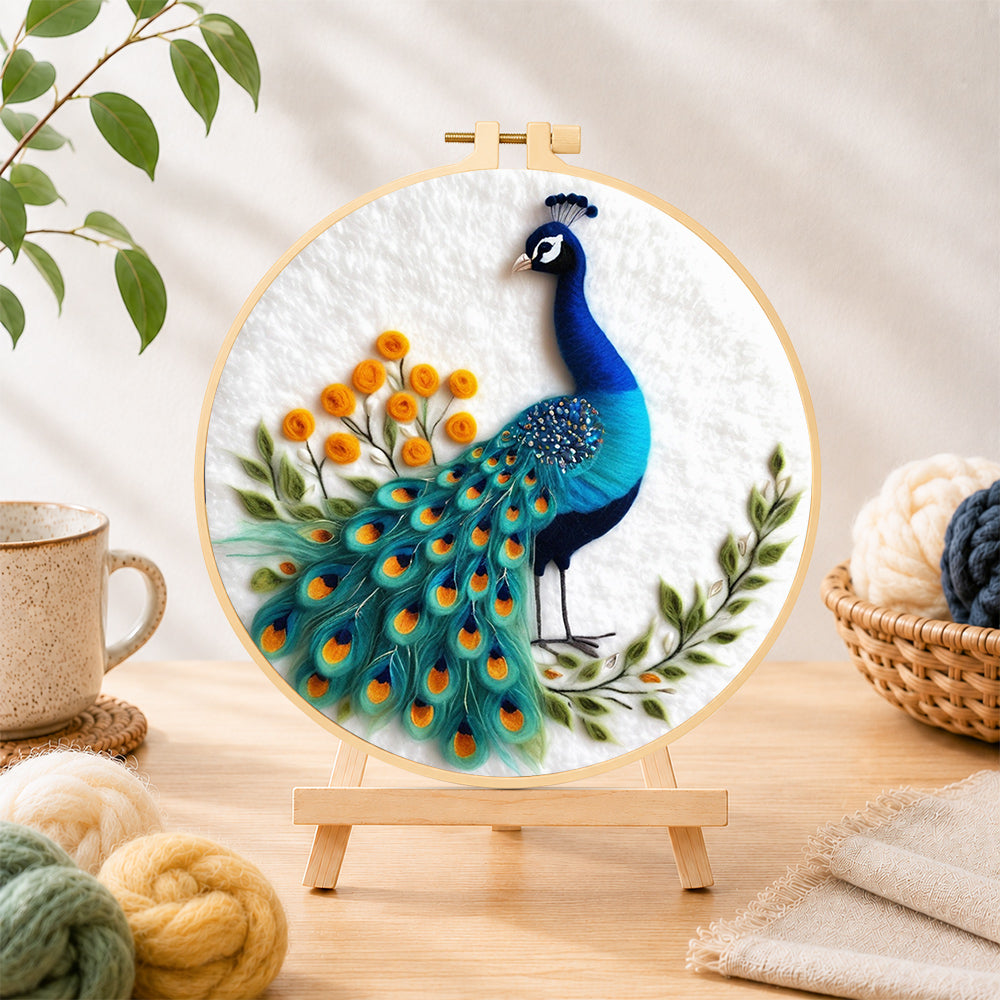 Finished majestic blue peacock needle felting displayed on a wooden easel