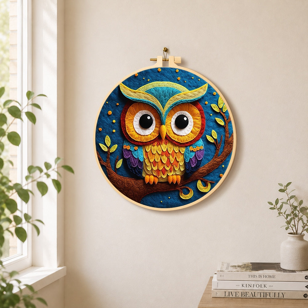 Majestic rainbow owl on a branch needle felt wall art displayed in a bright home interior