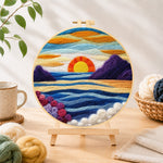 Finished majestic sunset and blue wavy sea needle felting displayed on a wooden easel
