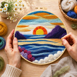 Creating the majestic sunset and blue wavy sea wool painting by hand with a felting needle