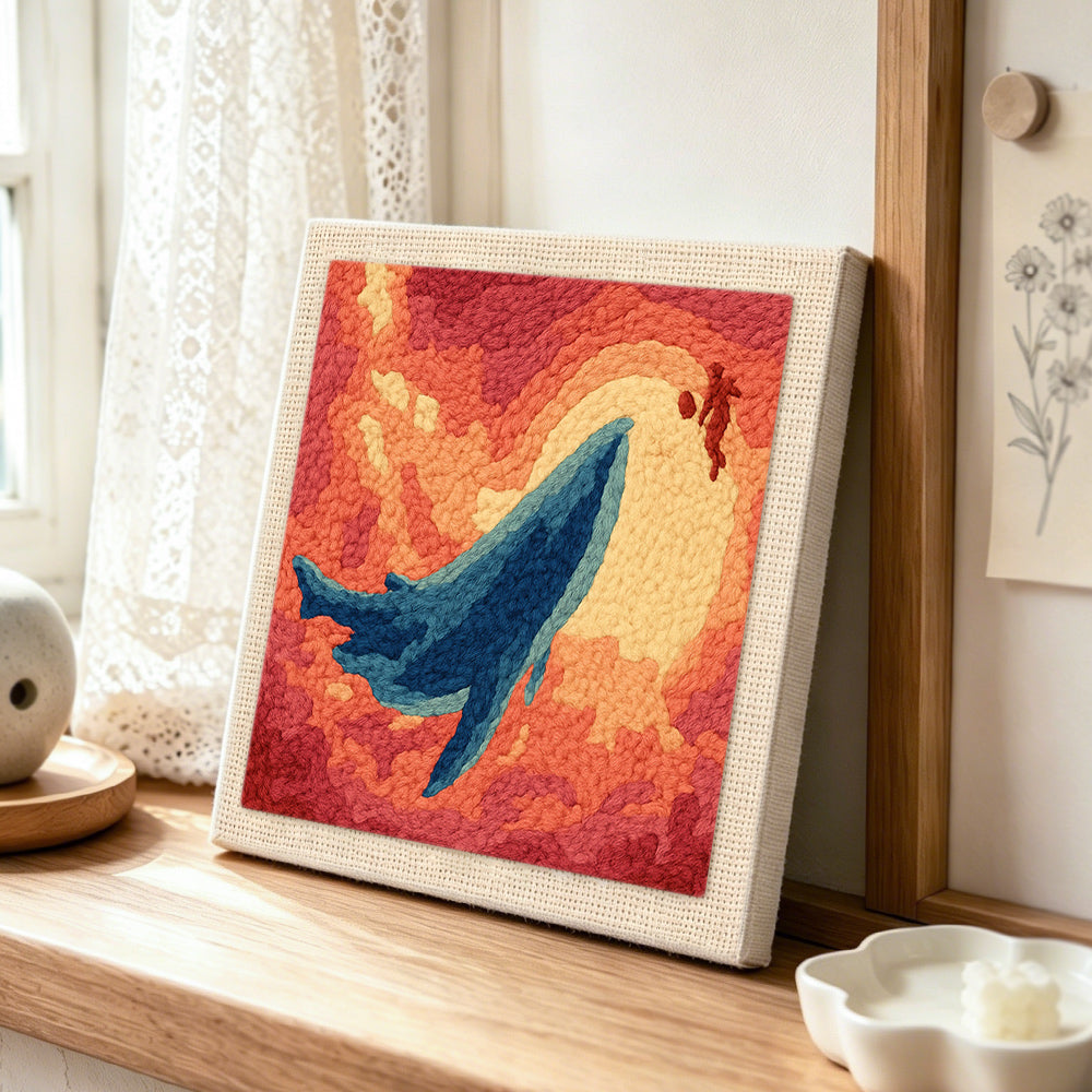Majestic whale sunset punch needle artwork displayed on a table