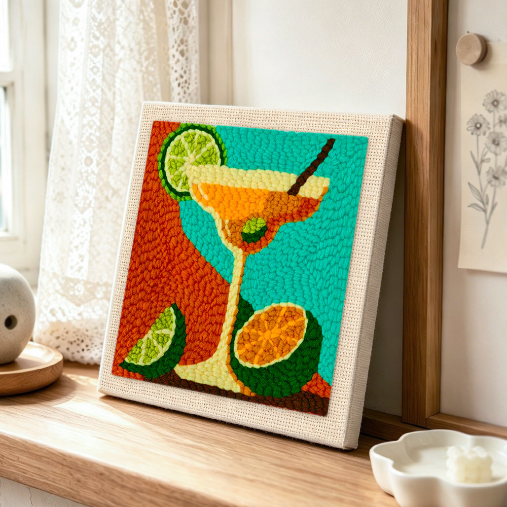 Margarita cocktail with lime and citrus punch needle artwork displayed on a table