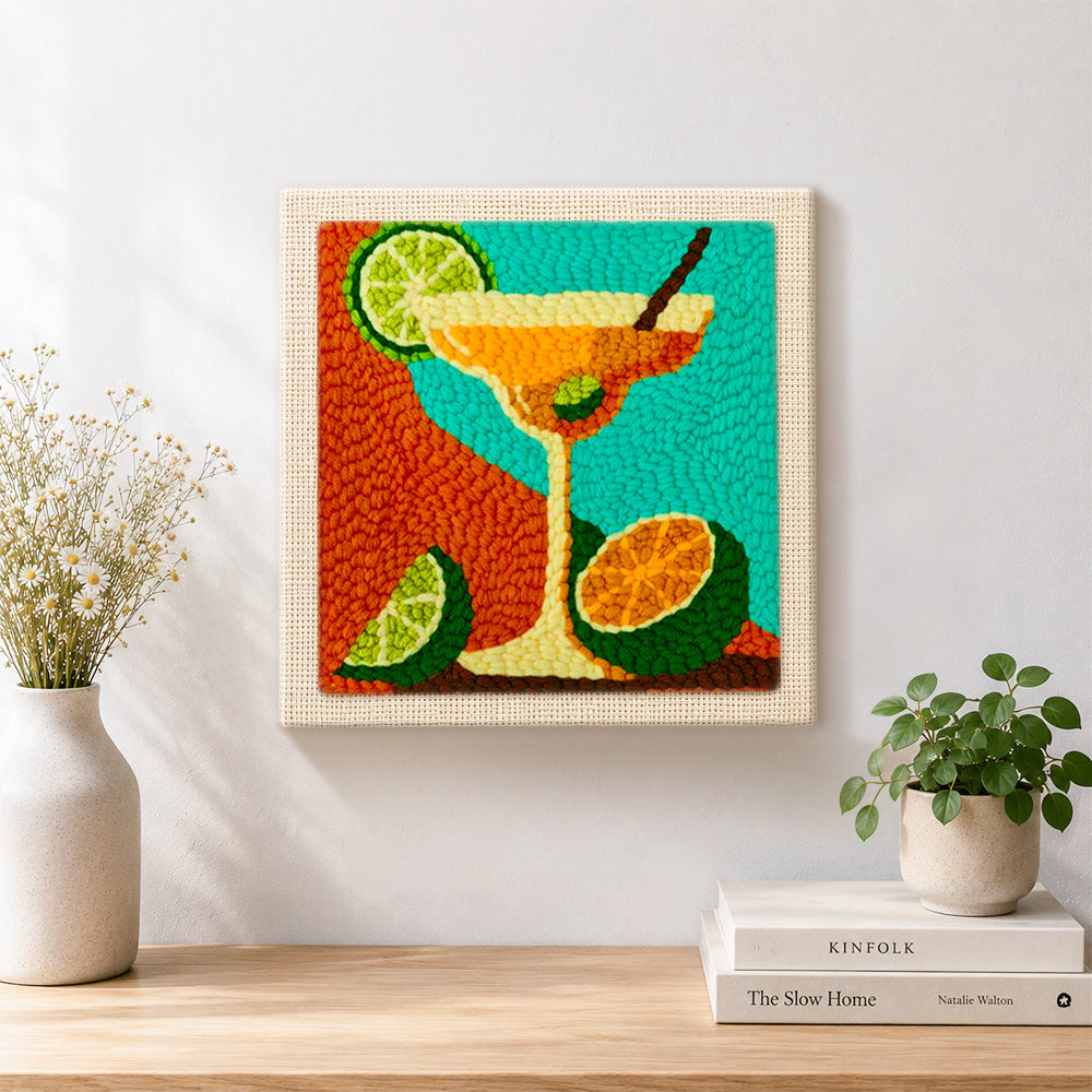 Finished margarita cocktail with lime and citrus artwork displayed on a wall