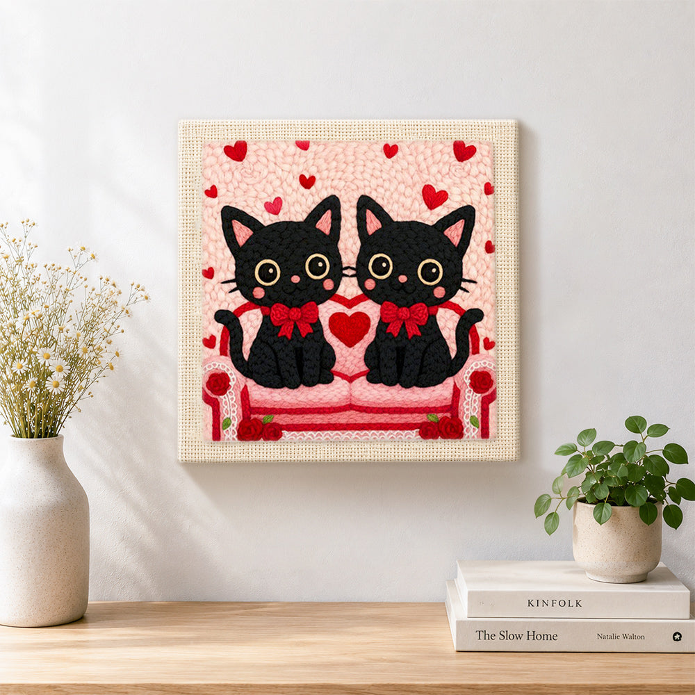 Finished matching black cats with red bows artwork displayed on a wall