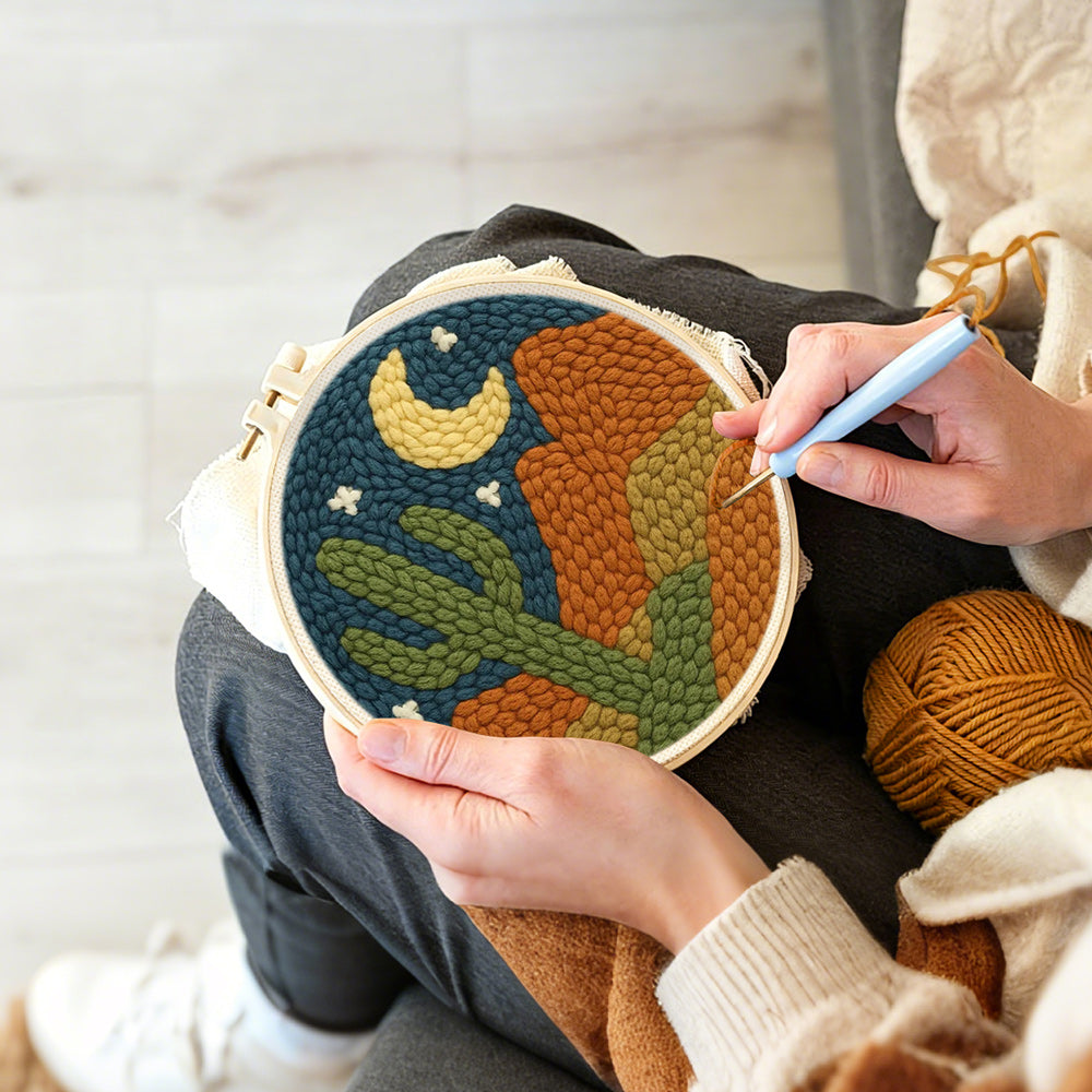 Creating handmade midnight desert cactus punch needle artwork