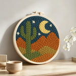 Midnight desert cactus punch needle artwork displayed on a table