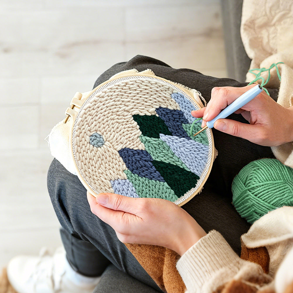 Creating handmade minimal mountain landscape with moon punch needle artwork