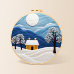minimalist blue mountains and snowy house needle felting kit for beginners with a round wooden frame