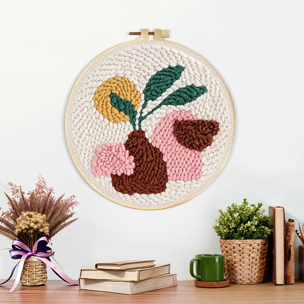 Finished minimalist brown vase and green leaves artwork displayed on a wall