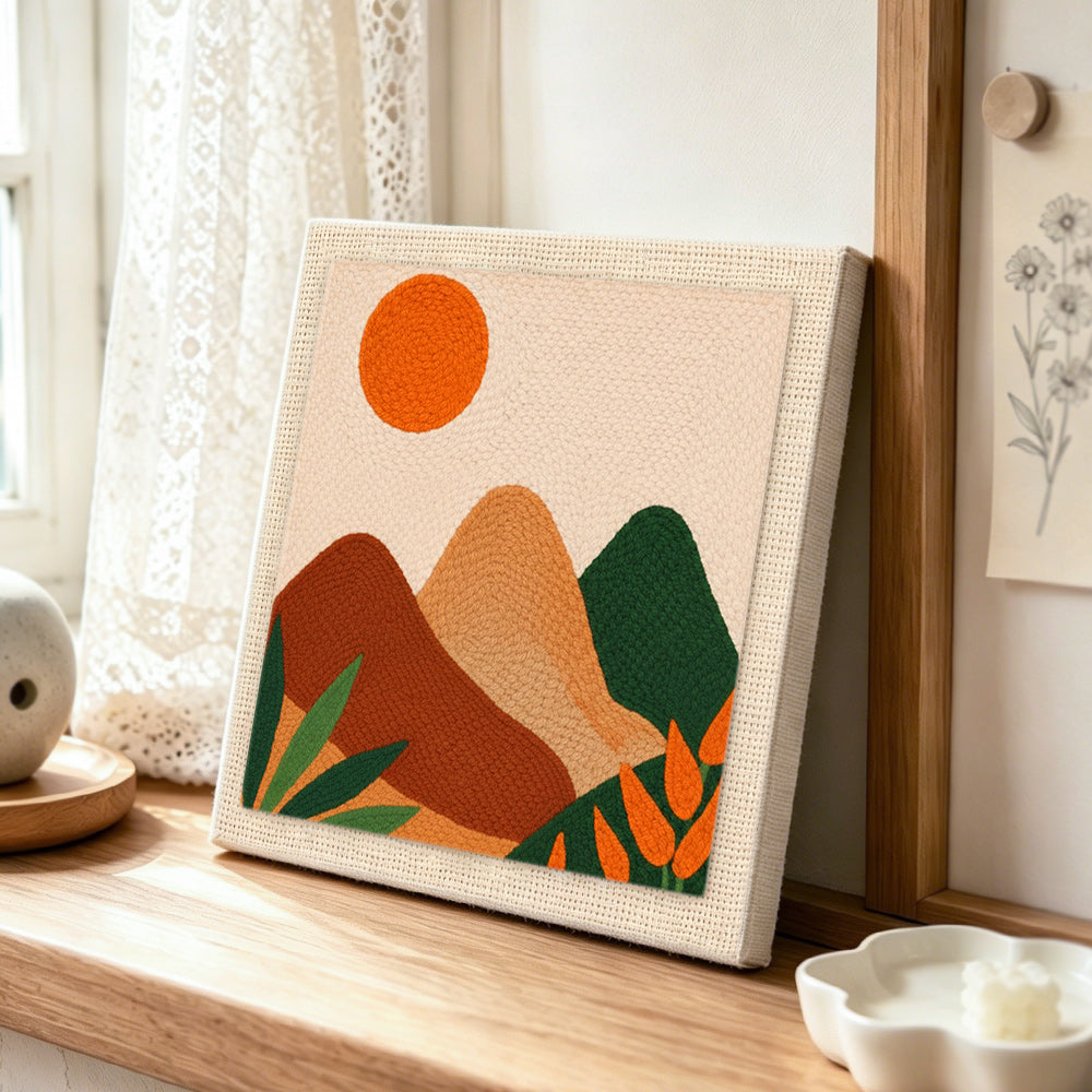 Minimalist geometric hills punch needle artwork displayed on a table