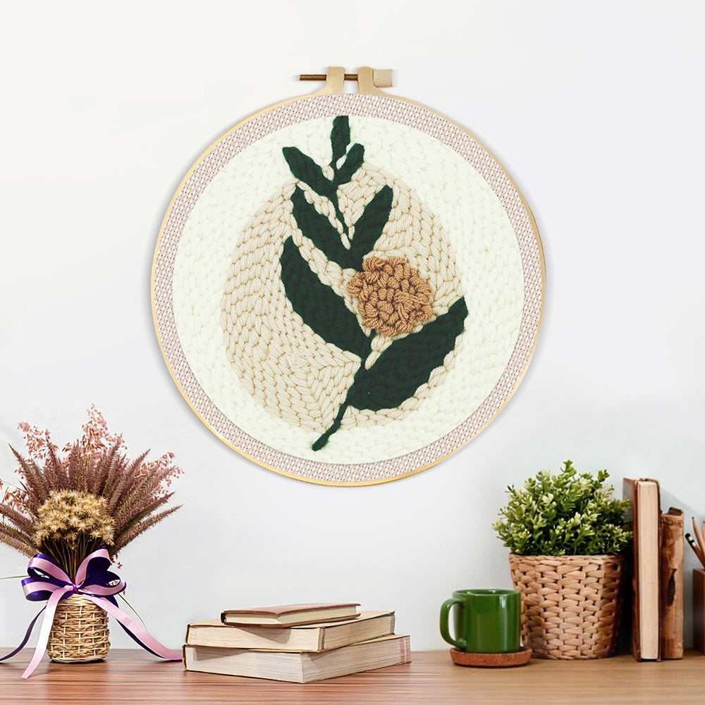 Finished minimalist green leaves and beige flower artwork displayed on a wall