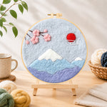 Finished minimalist mount fuji needle felting displayed on a wooden easel