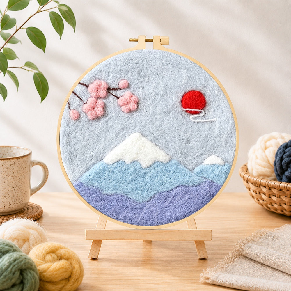 Finished minimalist mount fuji needle felting displayed on a wooden easel