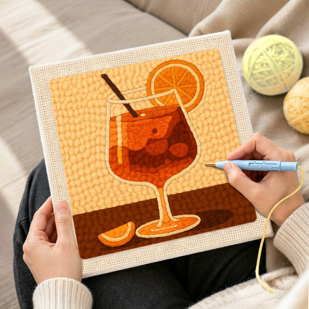 Creating handmade minimalist orange cocktail with straw and citrus punch needle artwork