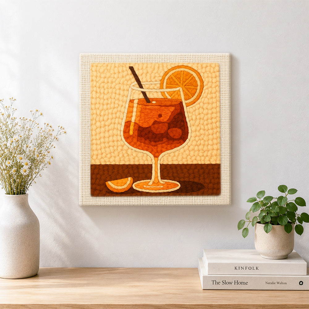 Finished minimalist orange cocktail with straw and citrus artwork displayed on a wall