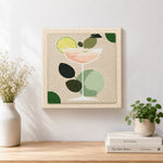 Finished minimalist peach cocktail with lime artwork displayed on a wall