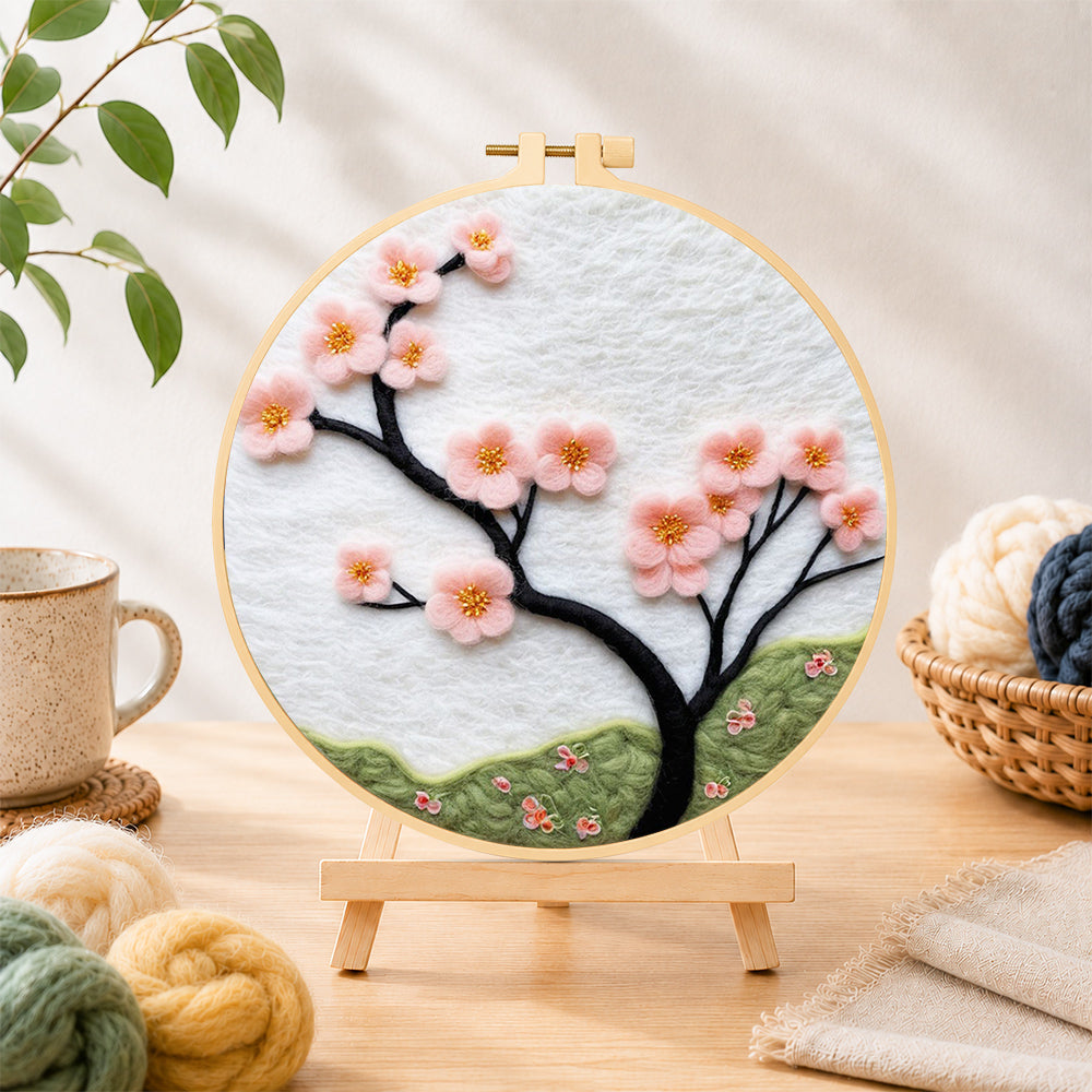 Finished minimalist pink flower branch needle felting displayed on a wooden easel