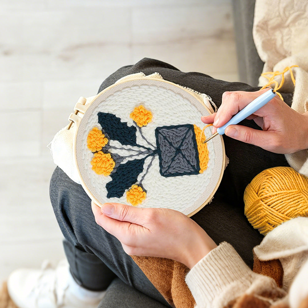 Creating handmade minimalist potted yellow flowers punch needle artwork