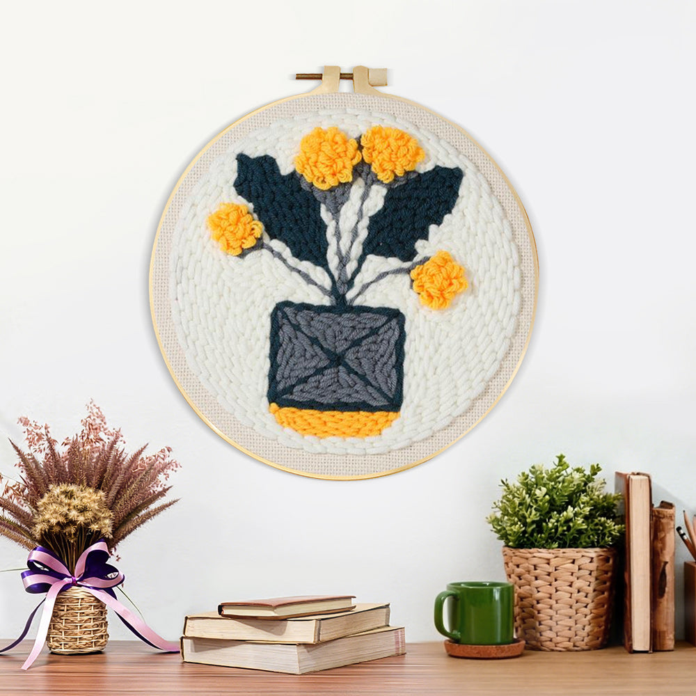 Finished minimalist potted yellow flowers artwork displayed on a wall