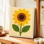 Minimalist sunflower punch needle artwork displayed on a table