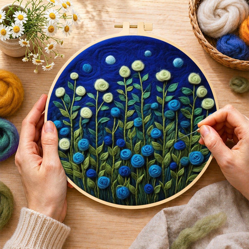 Creating the mint green and blue roses at night wool painting by hand with a felting needle