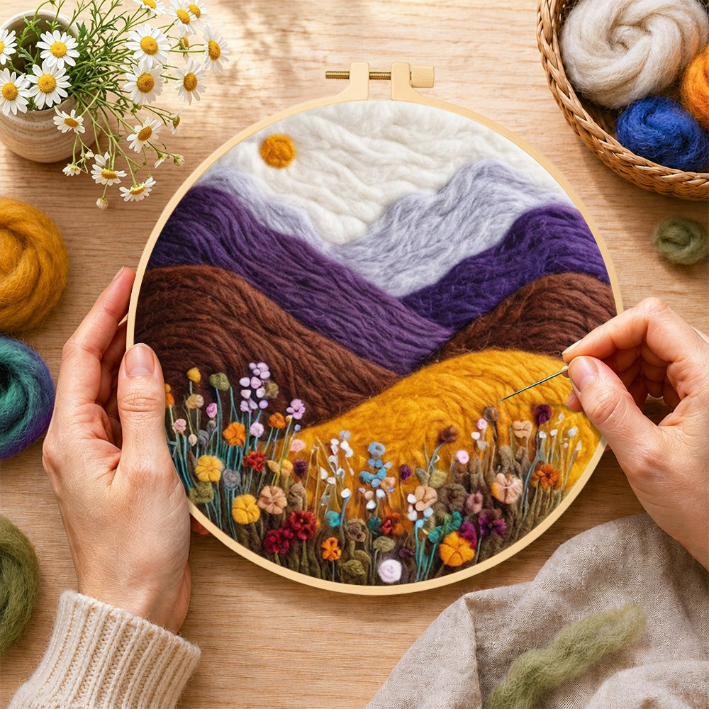 Creating the misty purple mountains and wildflowers wool painting by hand with a felting needle