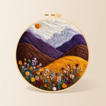 Misty purple mountains and wildflowers needle felting kit for beginners with a round wooden frame