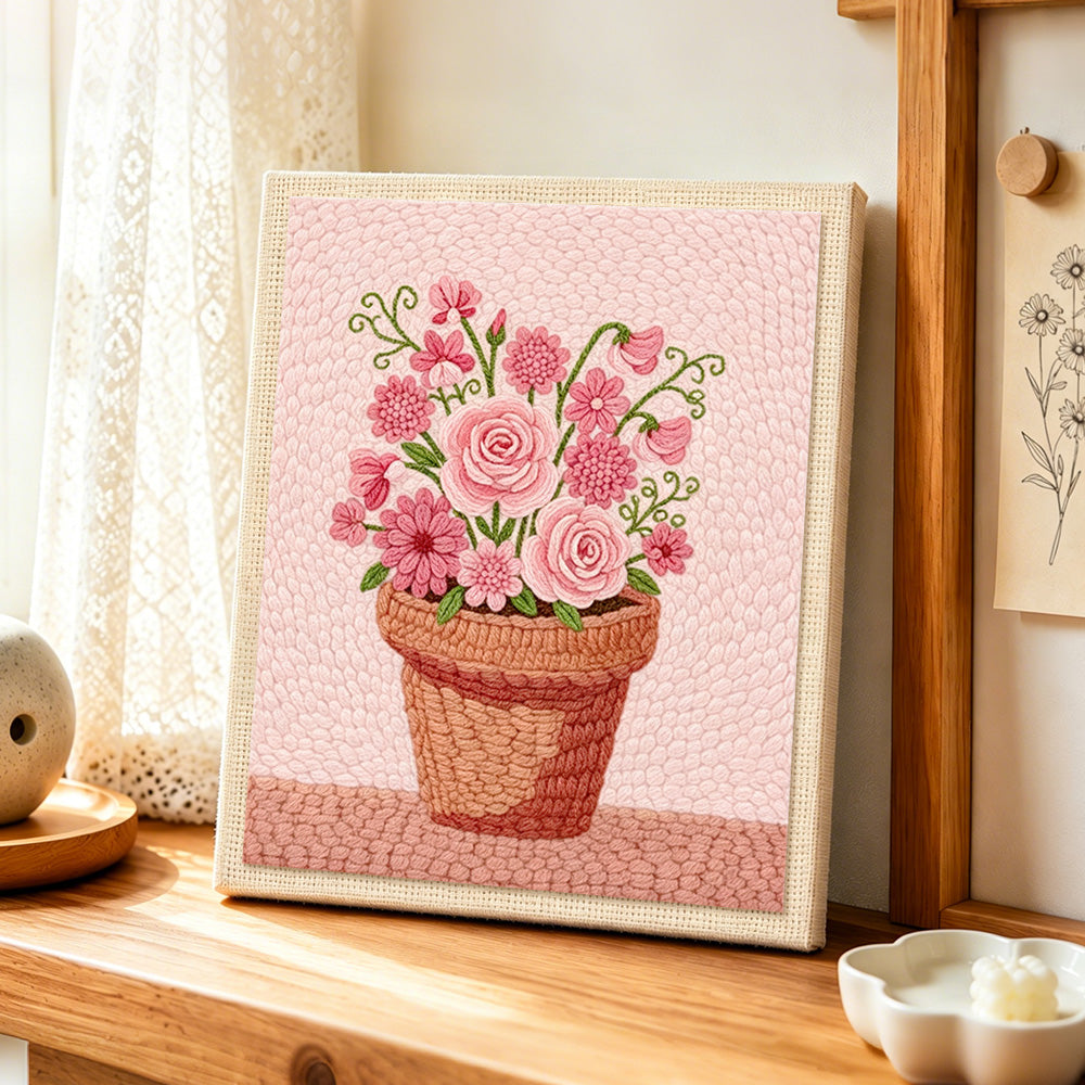 Mixed pink blooms in pot punch needle artwork displayed on a table