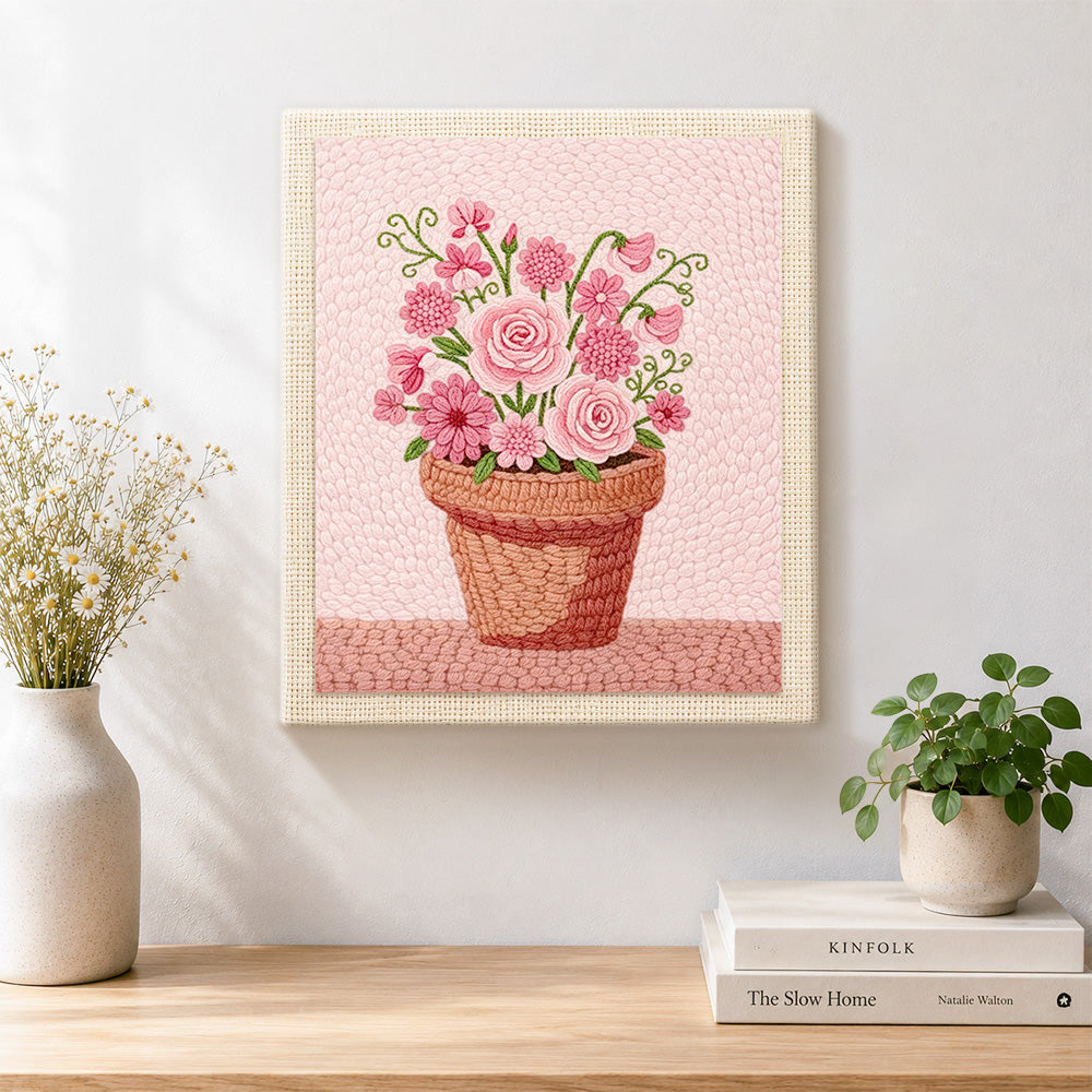 Finished mixed pink blooms in pot artwork displayed on a wall