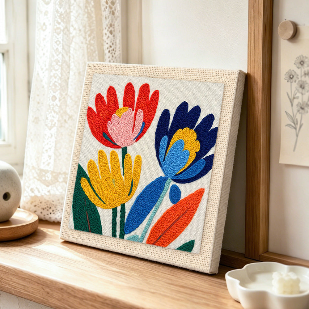 Modern abstract and colourful flowers punch needle artwork displayed on a table