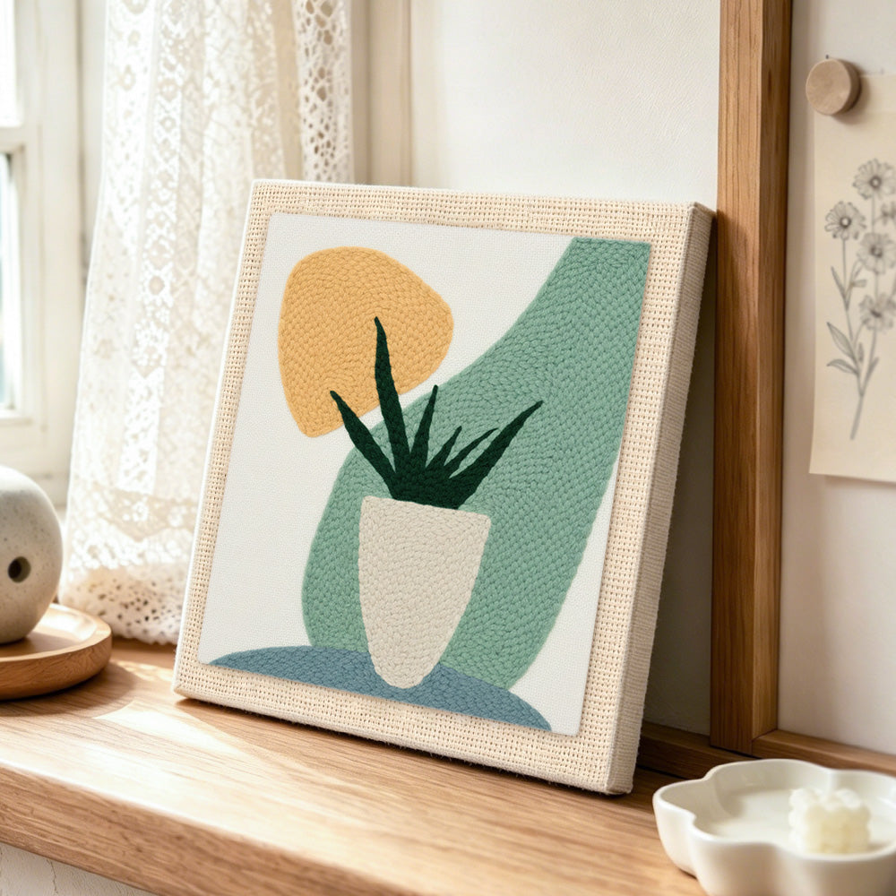 Modern abstract bonsai succulent punch needle artwork displayed on a table