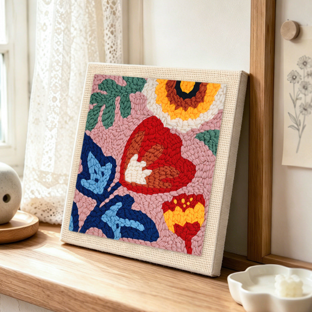 Modern abstract florals punch needle artwork displayed on a table