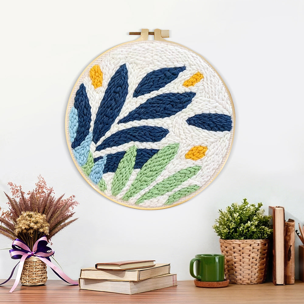 Finished modern blue and green leaves artwork displayed on a wall
