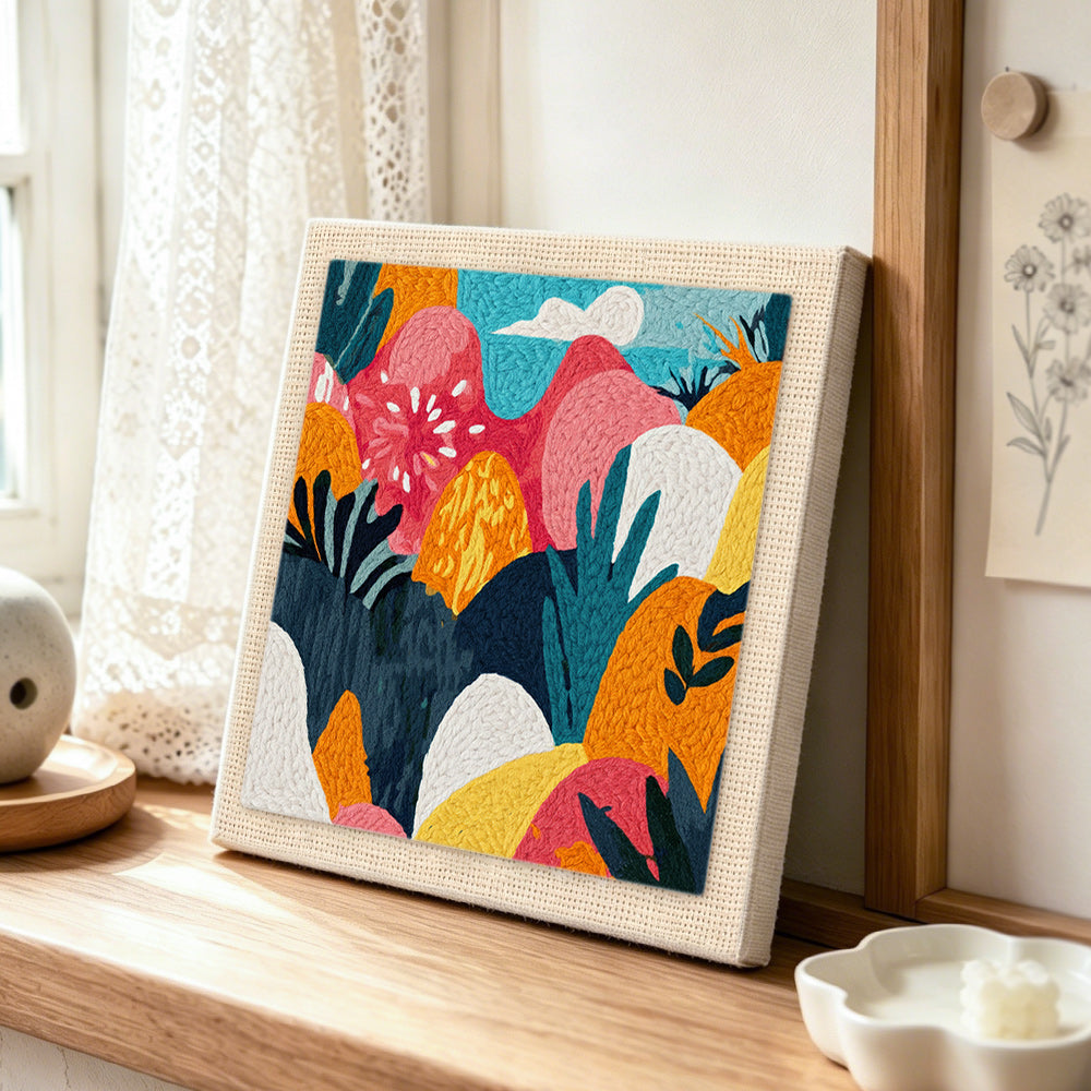 Modern floral and mountain pattern punch needle artwork displayed on a table