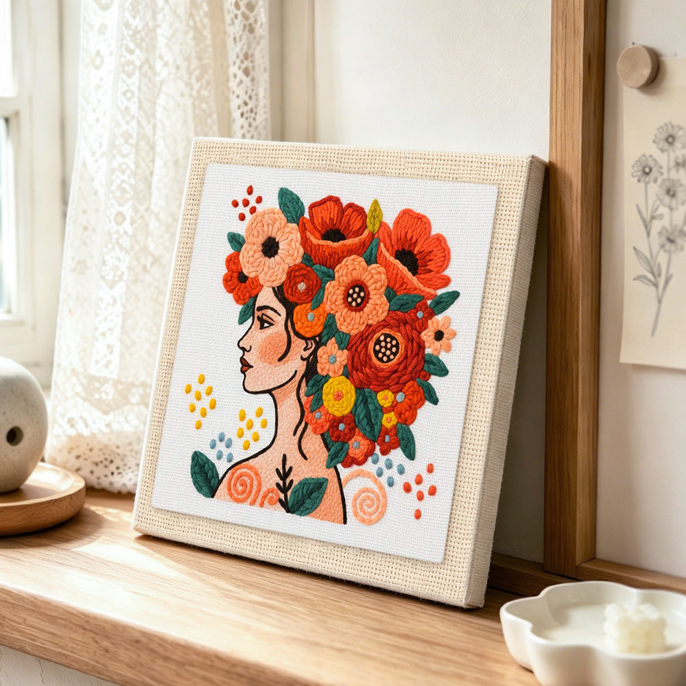 Modern woman with vibrant floral crown punch needle artwork displayed on a table
