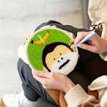 Creating handmade monkey and banana punch needle artwork