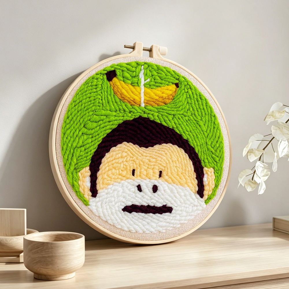 Monkey and banana punch needle artwork displayed on a table