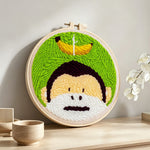 Monkey and banana punch needle artwork displayed on a table