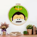 Finished monkey and banana artwork displayed on a wall