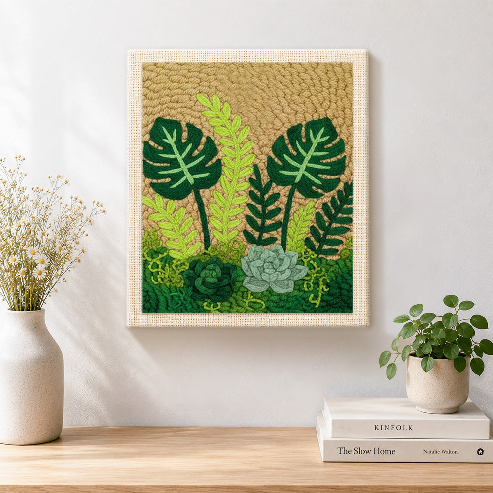 Finished monstera, ferns and succulents artwork displayed on a wall