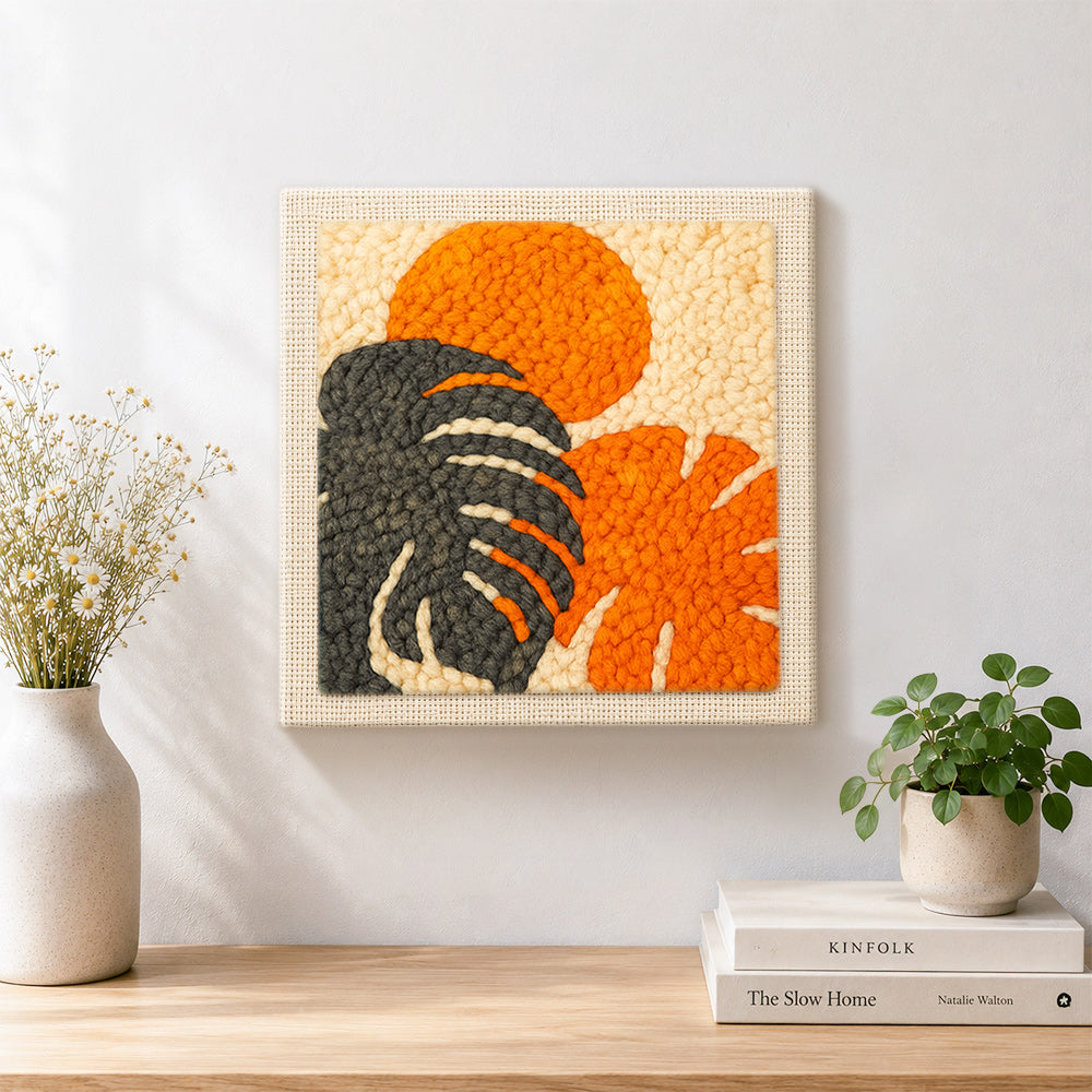 Finished monstera leaf and sun artwork displayed on a wall