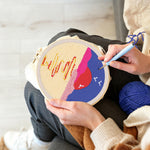 Creating handmade moon over sea with birds at sunset punch needle artwork