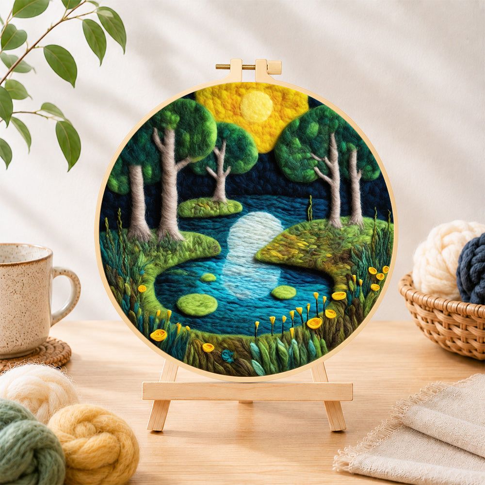 Finished moonlit forest lakemoonlit forest lake needle felting displayed on a wooden easel