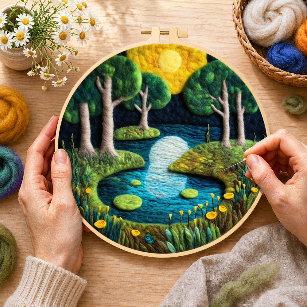 Creating the moonlit forest lake wool painting by hand with a felting needle