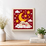 Finished moonlit puppies on clouds artwork displayed on a wall