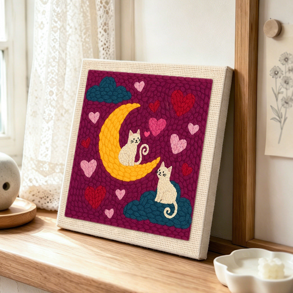 Moonlit white cats on clouds punch needle artwork displayed on a table