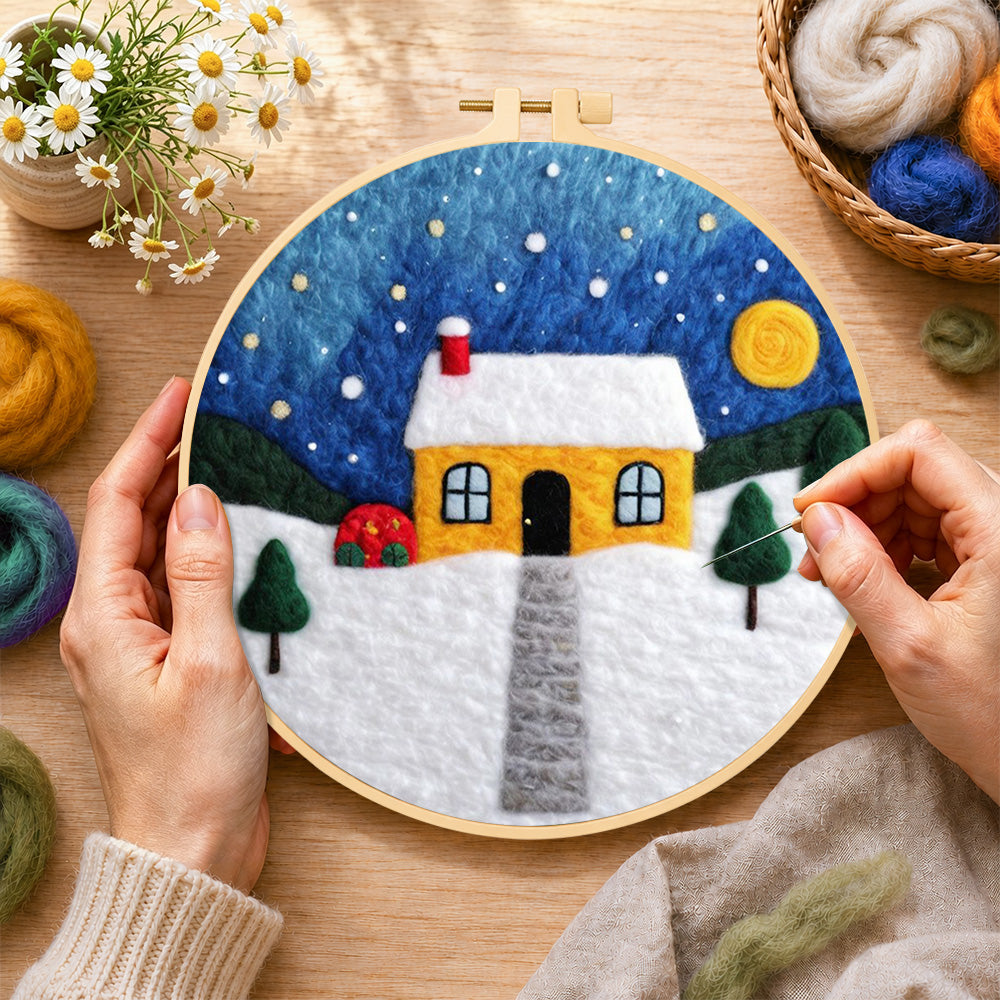 Creating the moonlit yellow house and red bushes wool painting by hand with a felting needle