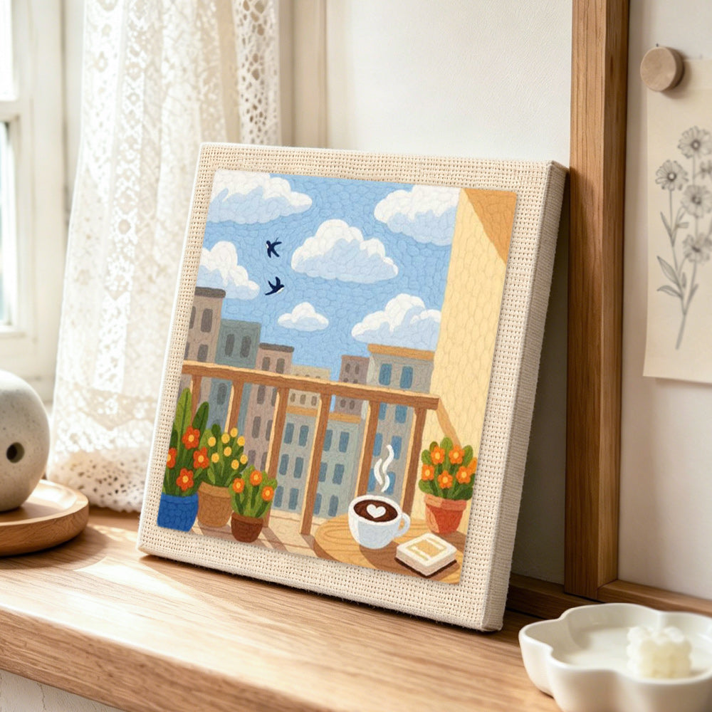 Morning coffee balcony and city skyline punch needle artwork displayed on a table