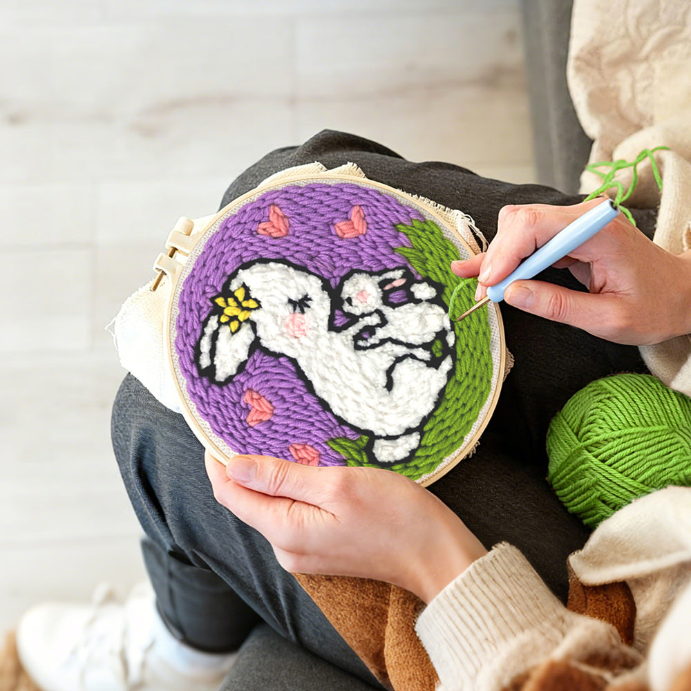 Creating handmade mother rabbit carrying baby bunny punch needle artwork