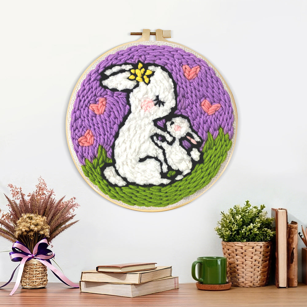 Finished mother rabbit carrying baby bunny artwork displayed on a wall